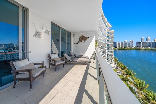 balcony with a water view and a city view