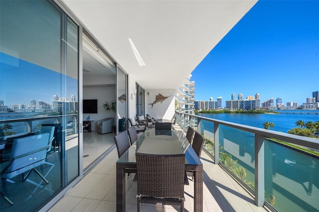 balcony featuring a view of city and a water view