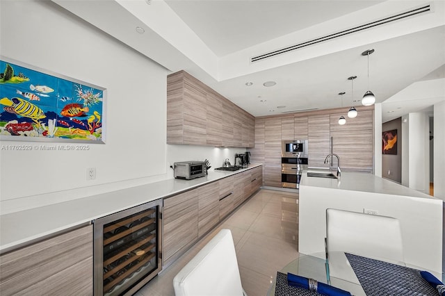 kitchen featuring light tile patterned floors, beverage cooler, a sink, light countertops, and modern cabinets