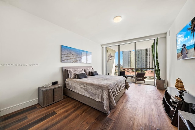 bedroom with access to outside, floor to ceiling windows, baseboards, and dark wood-style flooring