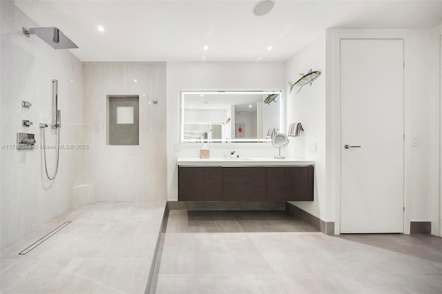 bathroom with vanity, recessed lighting, and a shower