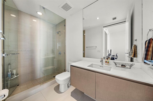 full bath with vanity, a shower stall, toilet, and visible vents