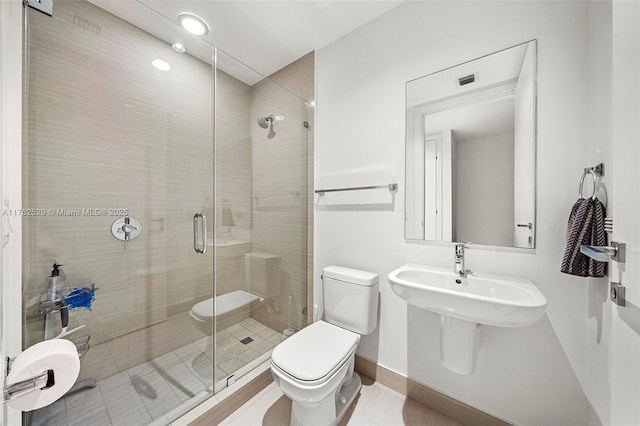 full bath featuring tile patterned floors, baseboards, toilet, and a shower stall