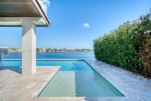 outdoor pool featuring a patio and a water view