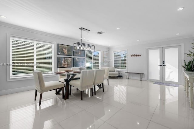 dining area with visible vents, baseboards, crown molding, and french doors