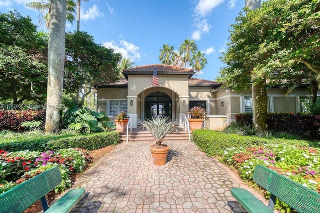 mediterranean / spanish-style house with stucco siding and a tile roof