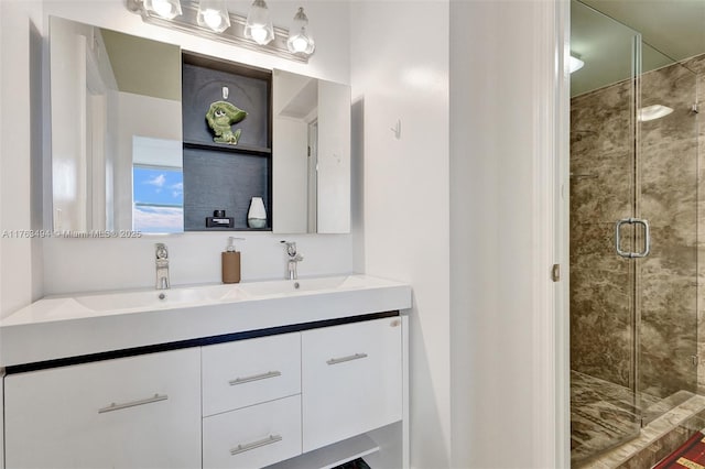 full bathroom with double vanity, a shower stall, and a sink