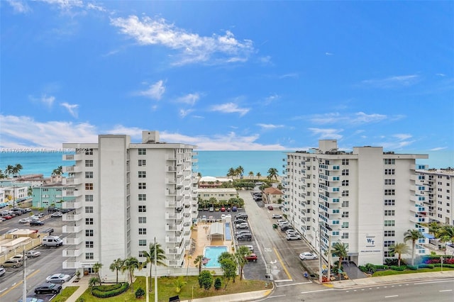 view of property with a water view and a view of city