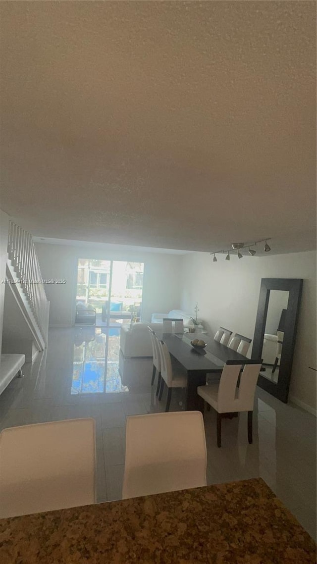 unfurnished dining area with a textured ceiling