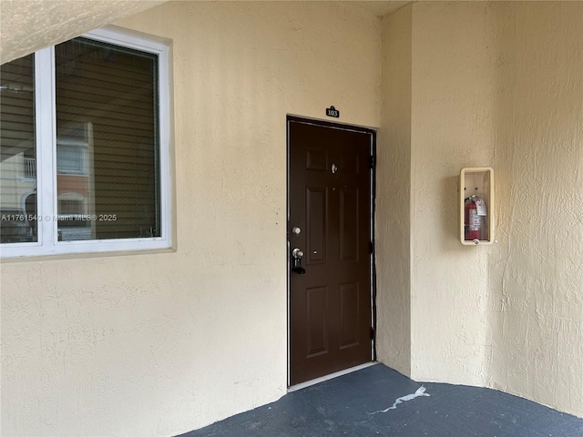 property entrance featuring stucco siding