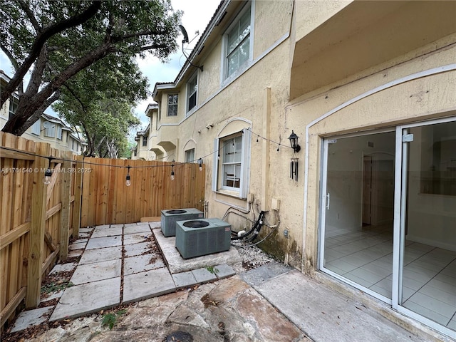 view of patio with central AC and fence