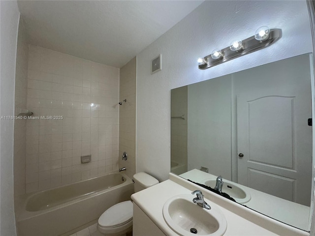 full bathroom with vanity, visible vents, bathtub / shower combination, toilet, and a textured wall