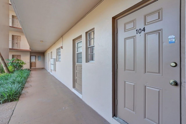 entrance to property featuring stucco siding