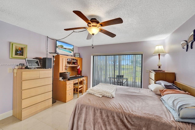 bedroom featuring light tile patterned flooring, baseboards, a textured ceiling, and ceiling fan