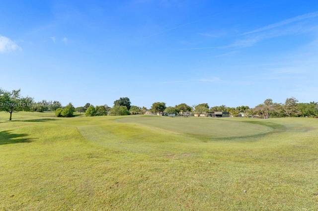 view of property's community featuring a lawn and golf course view