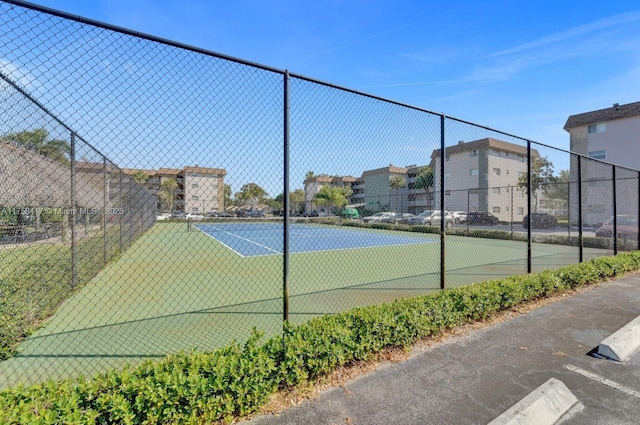 view of tennis court with fence