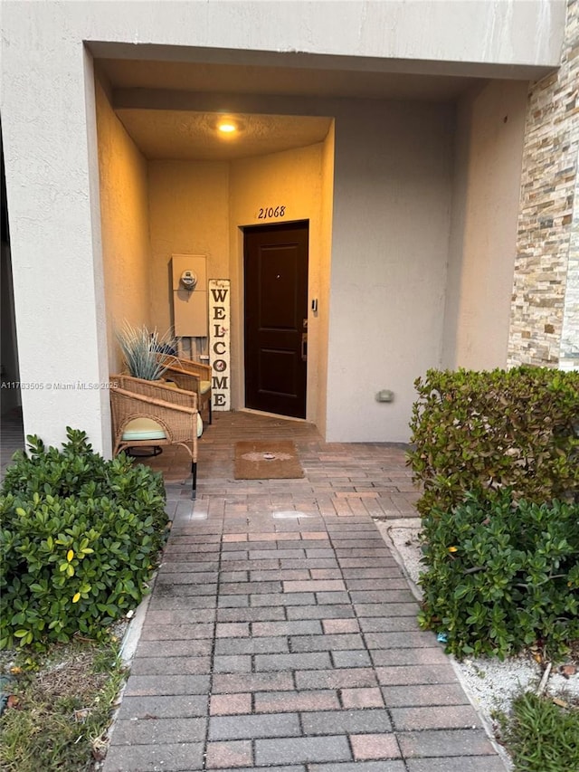 property entrance featuring stucco siding