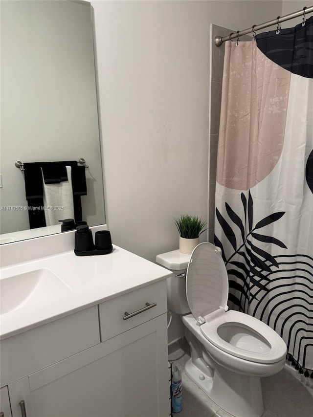 bathroom featuring toilet, vanity, and a shower with curtain