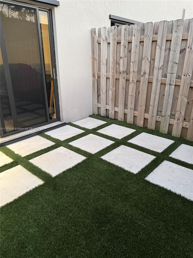 view of yard featuring a patio and fence