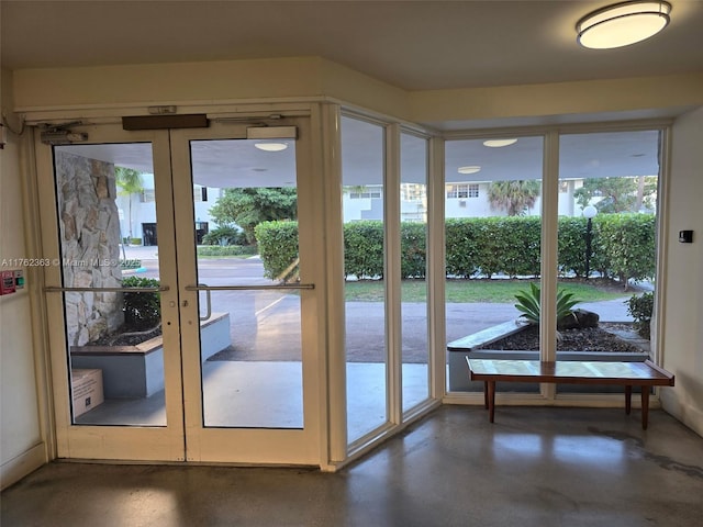 doorway to outside with french doors and concrete flooring