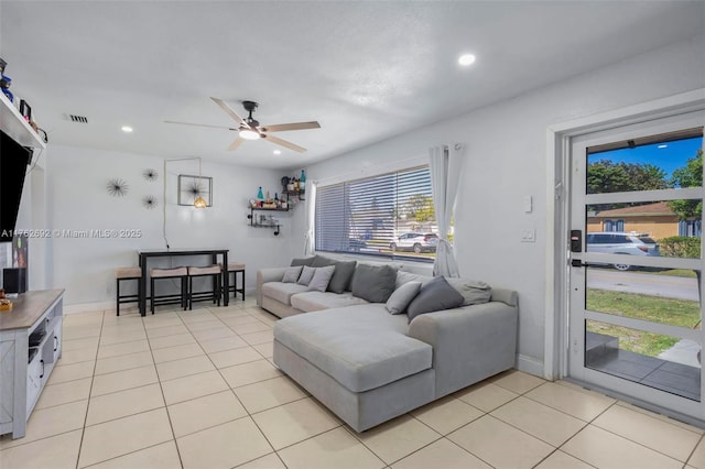 living area featuring light tile patterned floors, visible vents, recessed lighting, and ceiling fan