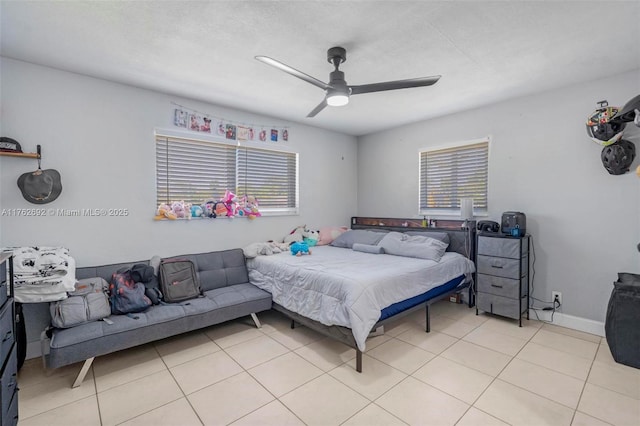 bedroom with light tile patterned flooring, a ceiling fan, and baseboards