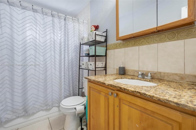 bathroom featuring vanity, tile patterned flooring, shower / bath combo with shower curtain, tile walls, and toilet