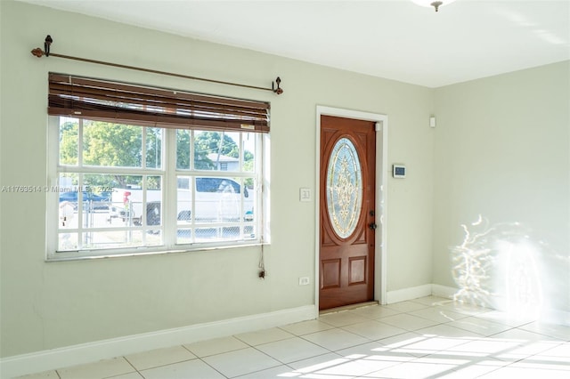 entrance foyer featuring light tile patterned floors and baseboards