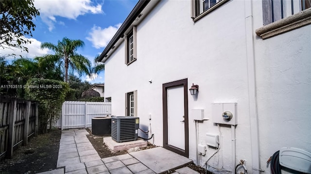 exterior space featuring cooling unit and a fenced backyard