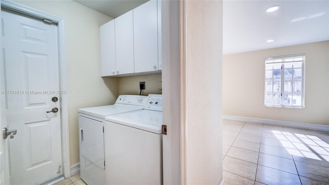 laundry area featuring light tile patterned floors, baseboards, recessed lighting, separate washer and dryer, and cabinet space