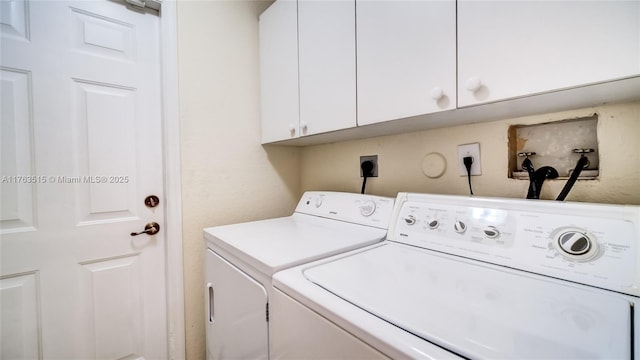 laundry area with cabinet space and washer and clothes dryer