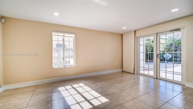 spare room featuring tile patterned floors, recessed lighting, and baseboards