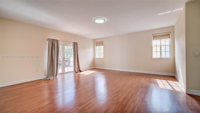 unfurnished room featuring baseboards and wood finished floors