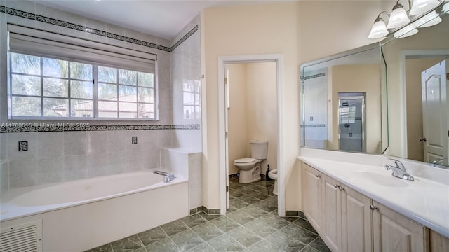 full bathroom featuring visible vents, toilet, a bidet, a garden tub, and vanity