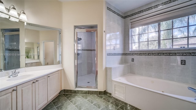 bathroom featuring visible vents, baseboards, a garden tub, a stall shower, and vanity