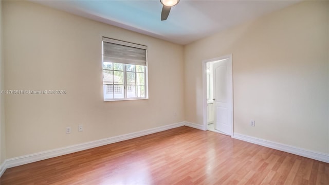 unfurnished room with baseboards, light wood-style floors, and ceiling fan