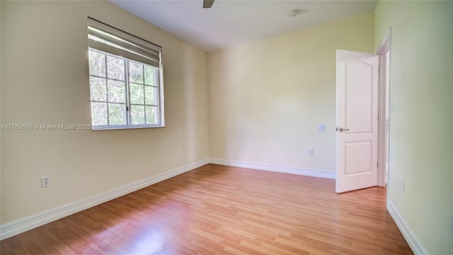 unfurnished room featuring baseboards, light wood-style floors, and a ceiling fan