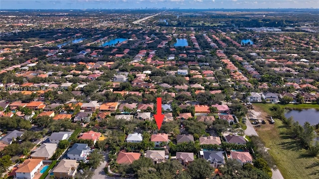 bird's eye view featuring a residential view and a water view