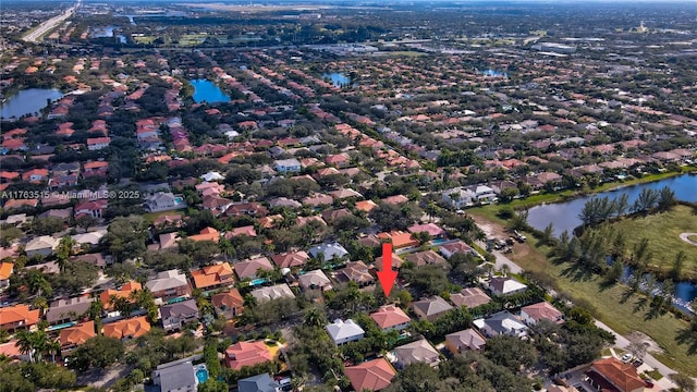 birds eye view of property with a residential view and a water view