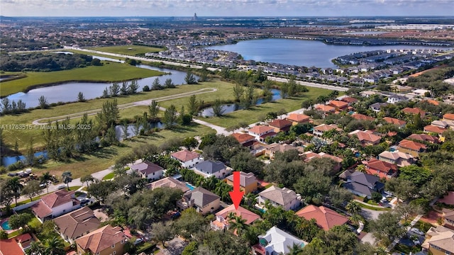 drone / aerial view with a water view and a residential view