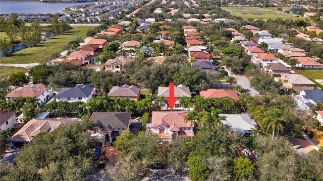 birds eye view of property featuring a residential view and a water view