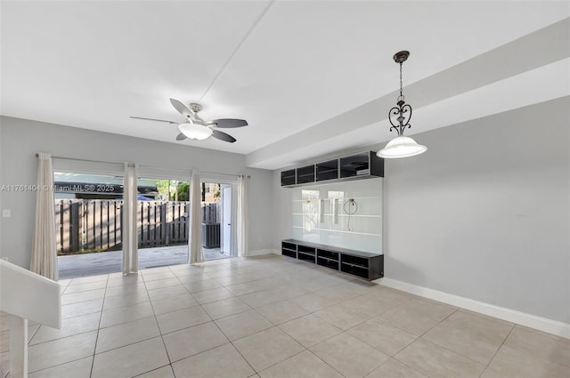 interior space featuring tile patterned floors, baseboards, and ceiling fan