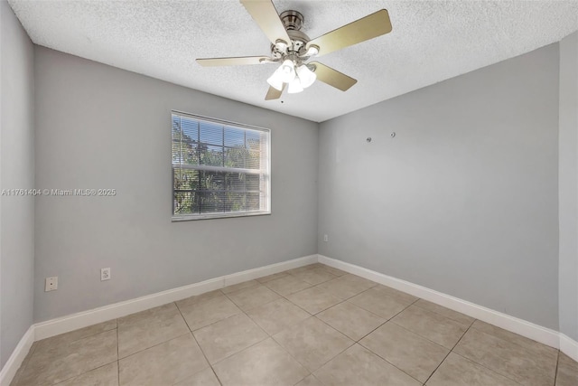 unfurnished room featuring a textured ceiling, light tile patterned floors, baseboards, and ceiling fan