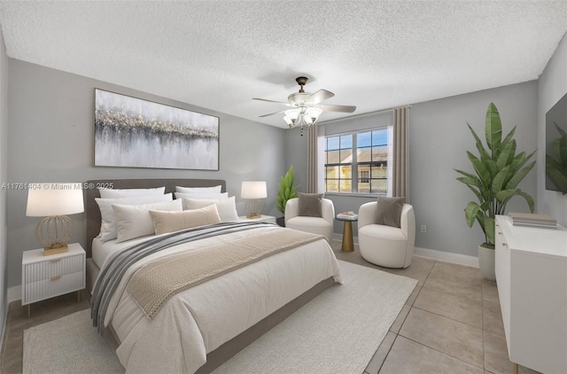 bedroom with light tile patterned flooring, a ceiling fan, baseboards, and a textured ceiling