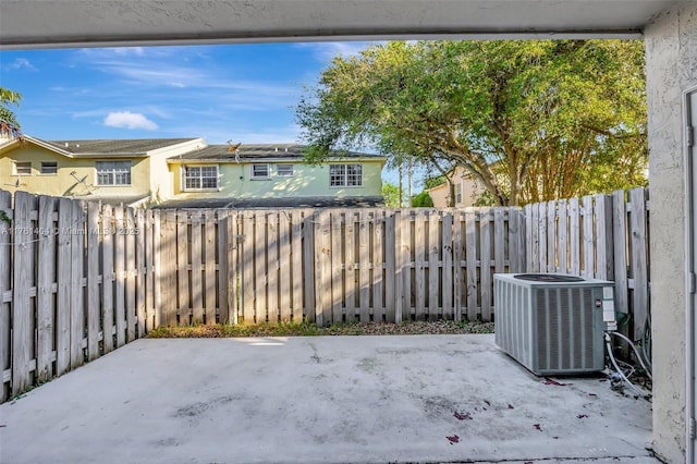 view of patio with cooling unit and a fenced backyard