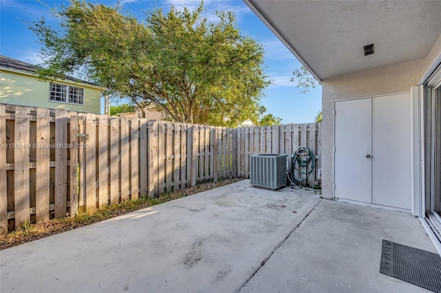 view of patio featuring central AC and a fenced backyard