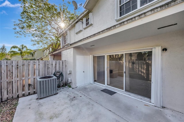 view of patio with fence and central AC