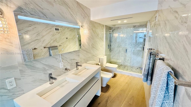 bathroom featuring a bidet, a sink, a shower stall, tile walls, and toilet