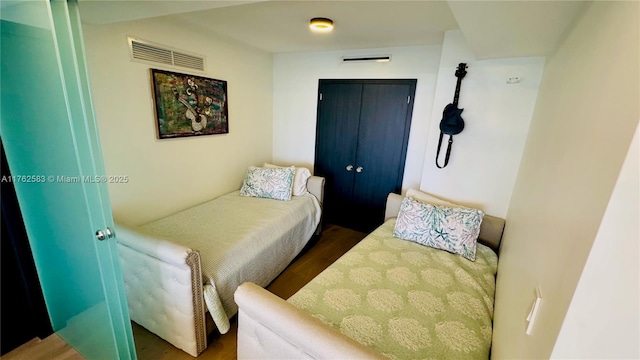 bedroom with wood finished floors and visible vents