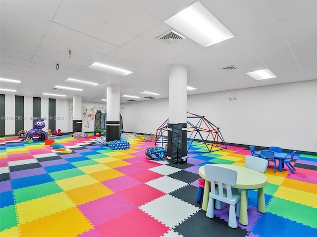 rec room with a paneled ceiling and visible vents